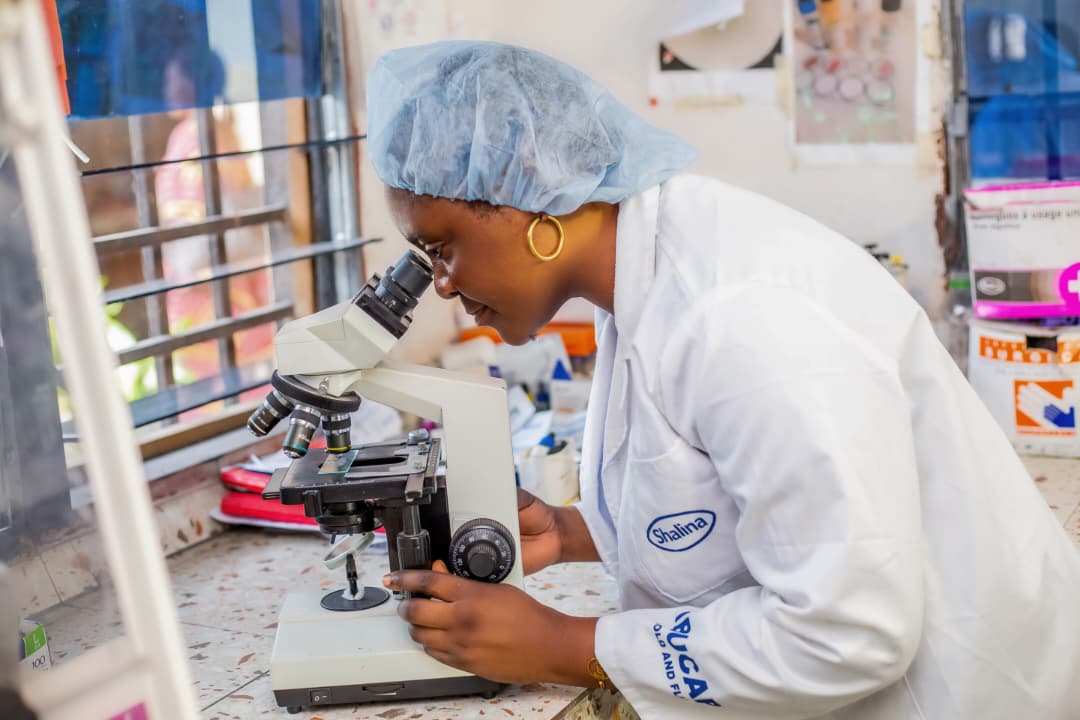 Laboratory technician examining a sample under a microscope
