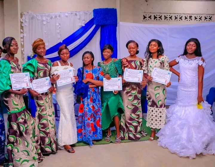 Program participants displaying certificates at a graduation ceremony