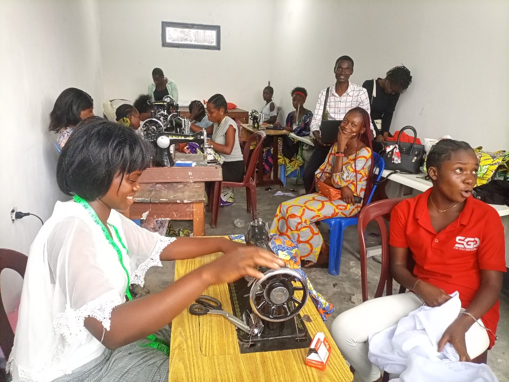 A vocational training graduate at her sewing workshop