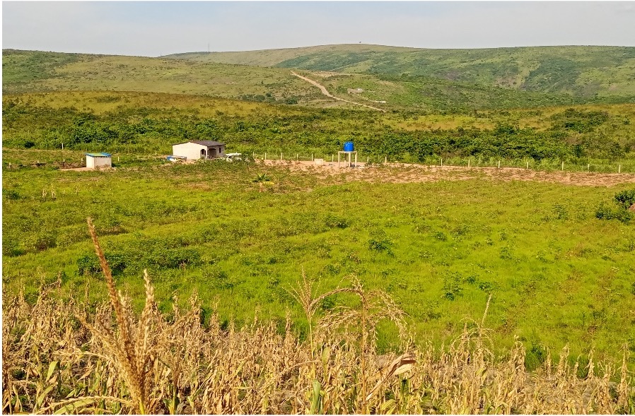Wide view of the BCP farm land with buildings and water tank in Inkwe Village